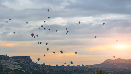 Rise sets of balloons in the early morning on sunrise background. Turkish Cappadocia.