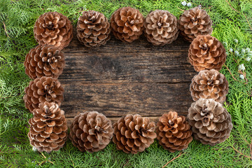 Christmas pine cone garland on the wooden rustic table