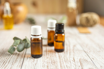 three bottles of essential oil on a white background, horizontal