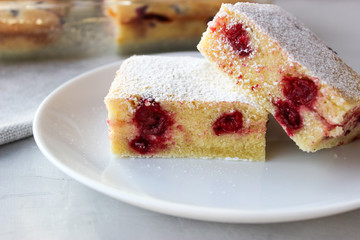 Cupcake with cherries and powdered sugar