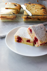 Cupcake with cherries and powdered sugar