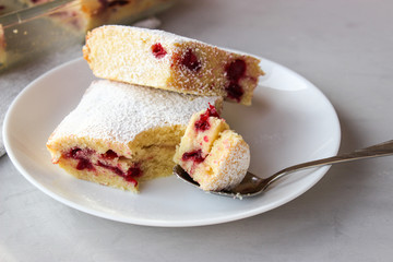 Cupcake with cherries and powdered sugar
