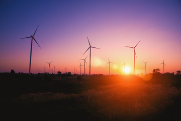 Obraz premium Silhouette of the wind turbine at sunrise in Huay Bong Wind Farm, Dan Khun Thot, Thailand. - Image