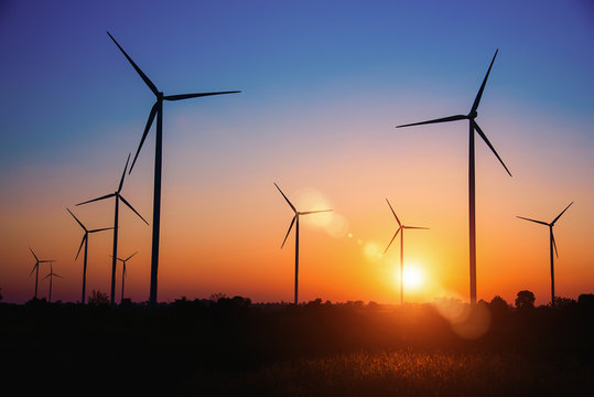 Silhouette of the wind turbine at sunrise in Huay Bong Wind Farm, Dan Khun Thot, Thailand. - Image