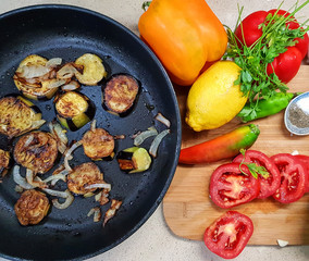 Cooking the vegetarian hot eggplant salad. Vegetable hot dish of eggplants, sweet pepper, tomato hot spices ana lemon, seasoned with garlic and olive oil. Stages of cooking. Batch of photos  