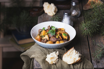 traditional irish beef and guinness beer stew with carrots, potatoes and green peas