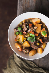 traditional irish beef and guinness beer stew with carrots, potatoes and green peas