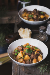 traditional irish beef and guinness beer stew with carrots, potatoes and green peas