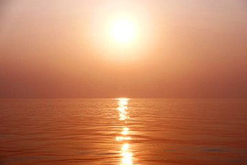 Dramatic image of the ocean in summer time. Beautiful sunset sky over the sea at in the evening. Sunrise in the morning of the sunny day in warm tone. Background or copy space.