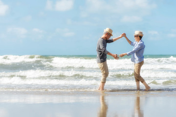 Asian senior couple dancing on the beach.elderly honeymoon together very happiness after retirement.plan life insurance.Activity after retirement on summertime