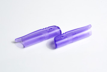Two pen caps on white background.