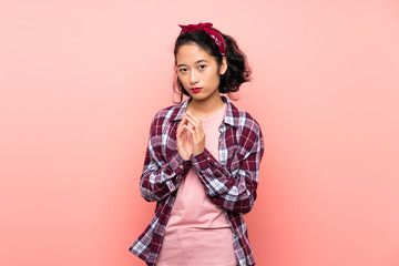 Asian young woman over isolated pink background scheming something
