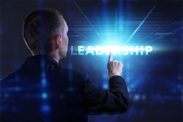 Business, Technology, Internet and network concept. Young businessman working on a virtual screen of the future and sees the inscription: Leadership