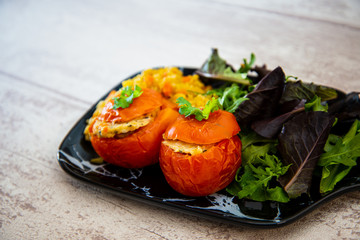 stuffed tomatoes with rice on a white plate