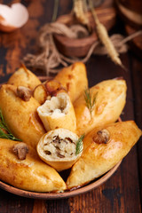 Delicious small savory hand pies filled with potatoes, champignons mushrooms and onion. 