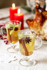 christmas hot cider. hot winter drink Cranberry Apple Cider Punch. Garnish with apples, oranges, and cranberries. hot apple cider with spices on a festive table on Christmas or New Year.