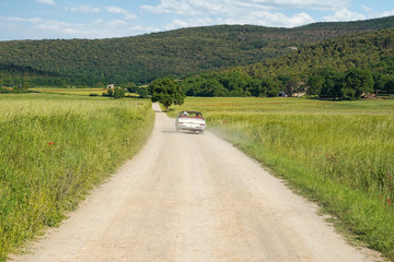 Classic vintage cabrio car on a country road
