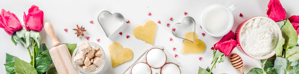 Valentine day baking background. Ingredients for cooking Valentine's heart cookies. Flour, eggs,...