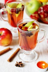 hot winter drink Cranberry Apple Cider Punch. Garnish with apples, oranges, and cranberries. hot apple cider with spices on a festive table on Christmas or New Year.