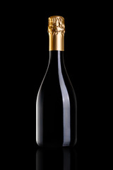 A bottle of champagne, isolated on a black background. The bottle is closed with gold foil.
