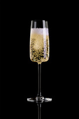 A glass of champagne isolated on a black background.