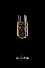 A glass of champagne isolated on a black background. Champagne in a glass without foam.