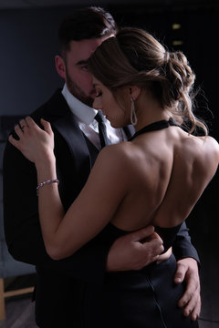 The man unbuttons the dress modestly embracing his girl