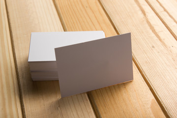 Business card blank on wooden background. Corporate Stationery, Branding Mock-up. Creative designer desk. Flat lay. Copy space for text