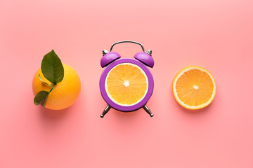 Ripe orange and slices on color background