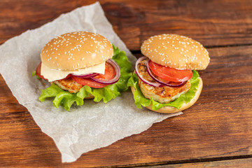 Sandwich with chicken cutlet. The roll is sprinkled with sesame seeds on top. Hamburger.