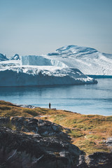 3 people taken photo of Humpback whale in Ilulissat diving in Greenland. Easy hiking route to the famous Kangia glacier near Ilulissat in Greenland. The Ilulissat Icefjord seen from the viewpoint. © Mathias
