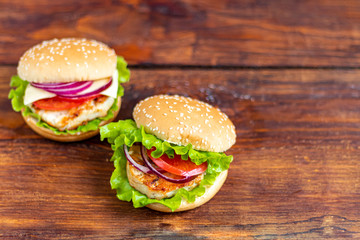 Sandwich with chicken cutlet. The roll is sprinkled with sesame seeds on top. Hamburger.