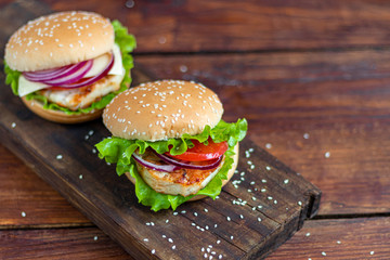 Sandwich with chicken cutlet. The roll is sprinkled with sesame seeds on top. Hamburger.