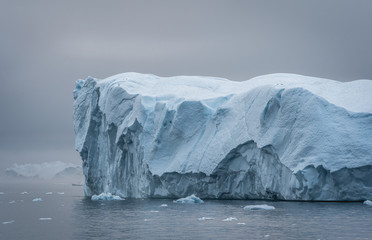 Greenland. The biggest glacier on a planet Jakobshavn. Huge icebergs of different forms in the...