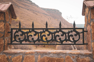 wrought iron fence made of metal and brickwork