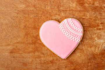 Pink cookie heart shaped with different patterns, wooden background