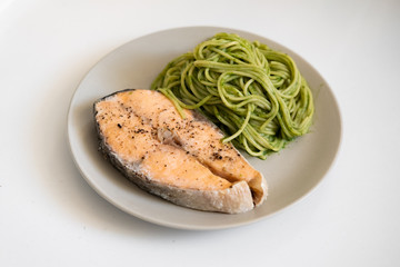 salmon steak and vegetable spaghetti. close-up. Vegetarian food. 