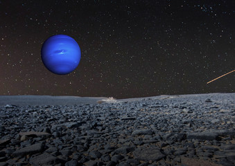 Rocky desert in Sudan, connected with a surreal sky, where the blue planet Neptune is standing, composite. Elements of this image furnished by NASA © Frank