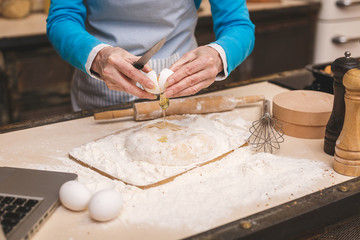 Close-up portrait of attractive senior aged woman is cooking on kitchen. Grandmother making tasty baking.