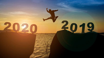 One man silhouettes jump, float across numbers, 2019 enters the year 2020.,ล}]