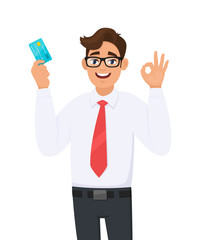 Young businessman showing credit, debit, ATM card and making okay or OK gesture sign with hand fingers. Person holding digital payment card. Male character design illustration. Modern lifestyle.