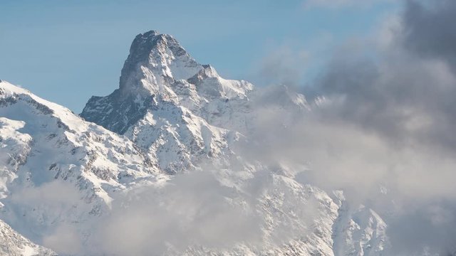 The Olan peak covered in fresh snow time-lapse with passing clouds (time-lapse). Valgaudemar Valley, Ecrins National Park, European Alps, France