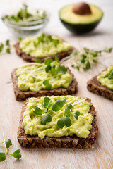 Whole grain sandwiches with avocado spread and microgreen