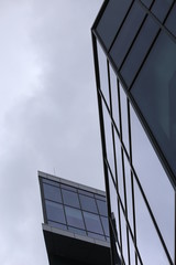 Obraz premium Abstract business modern city urban futuristic architecture background, motion blur, reflection in glass of high rise skyscraper facade, toned blue picture with bokeh. Real estate concept