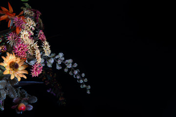 Colorful flowers located on the edges with a plain black background. Elegant flowers background with hollow for text and images