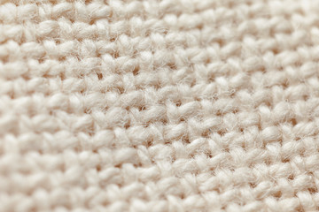 Background of wool material beige colour with shallow depth of field. Close up. Macro photo.