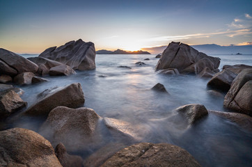 Obraz premium amazing travel landscape photo with Sunset of the iconic rocks of seychelles , Seascape on sea with long exposure and water wave