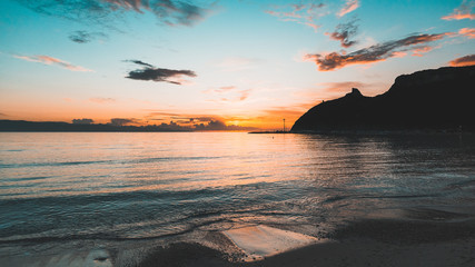 Silhouette sunrise on Poetto Beach  - obrazy, fototapety, plakaty