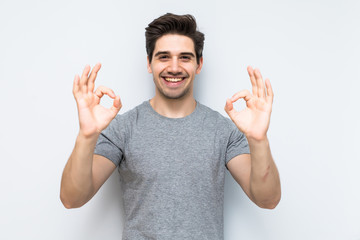 Happy man giving okay sign t on white background