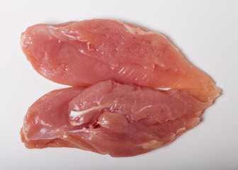 Raw chiken meat on a light background